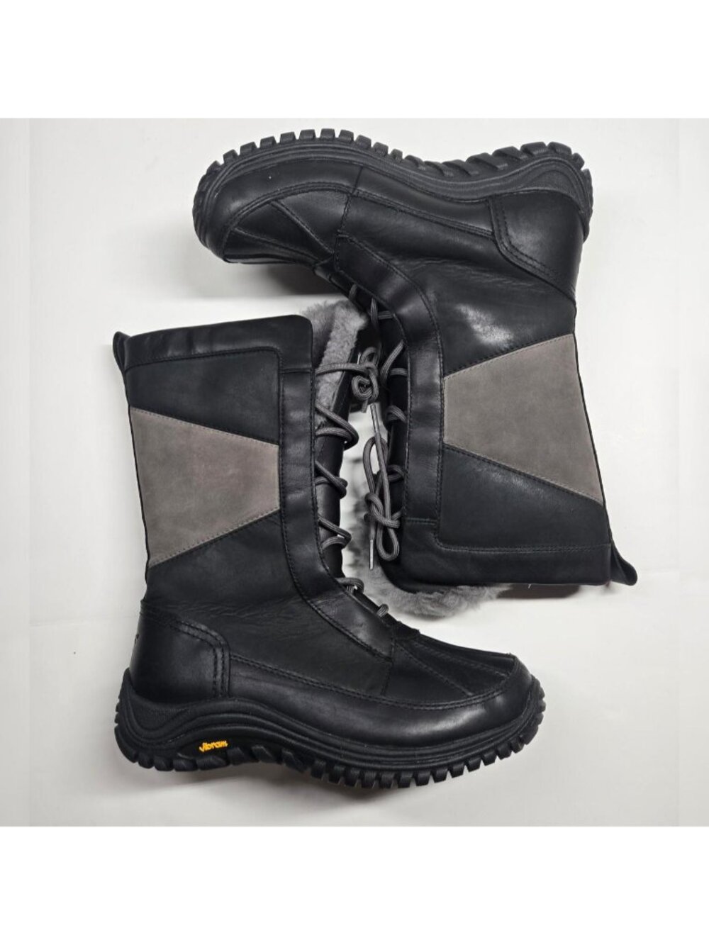 UGG Lace up tall sheepskin lined winter snow boots. black leather. waterproof.